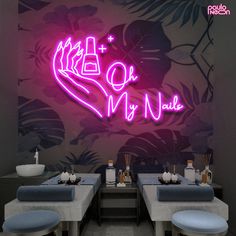 the neon sign is above two tables with place settings for food and drinks on them