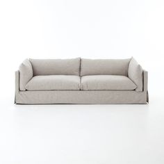 a gray couch sitting on top of a white floor