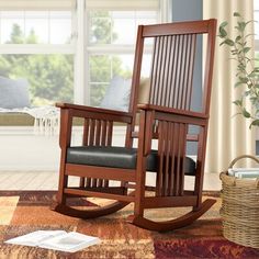 a rocking chair sitting on top of a wooden table