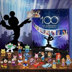 a group of disney figurines are shown in front of a poster for the 100th anniversary celebration