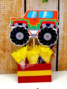 a red box with yellow tulips in front of a monster truck cutout