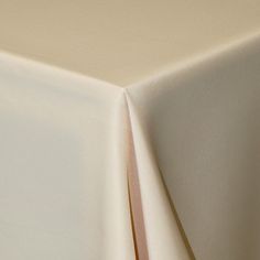 an image of a white table cloth on top of a bed sheet or coverlet