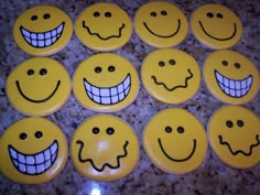 there are many smiley faces on the yellow buttons