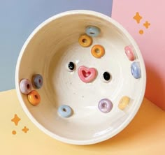 a bowl with buttons in the shape of a face