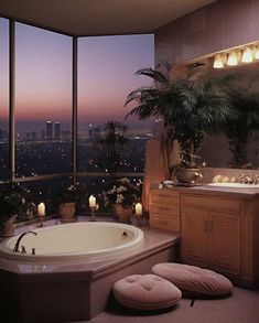 a bathroom with a large jacuzzi tub next to a window overlooking the city