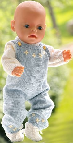 a baby doll that is standing in the grass