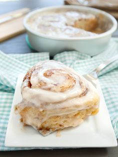 a cinnamon roll sitting on top of a white plate