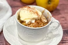 a cup filled with dessert sitting on top of a white saucer