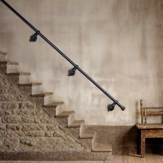 a wooden chair sitting next to a set of stairs