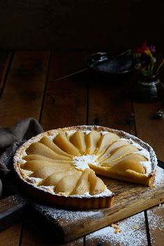 a pie sitting on top of a wooden cutting board