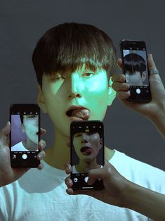 two people holding up their cell phones to take pictures with the same person's face