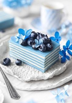 a piece of cake with blueberries on top