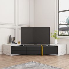 a flat screen tv sitting on top of a white cabinet