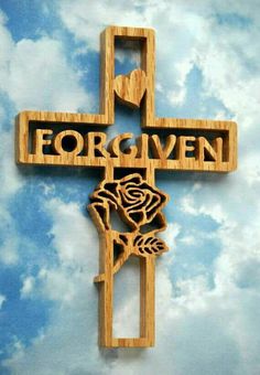 a wooden cross with the word forever carved into it and a rose on one side