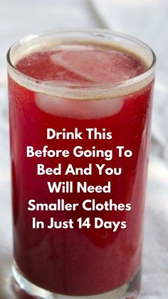 a glass filled with red liquid sitting on top of a table