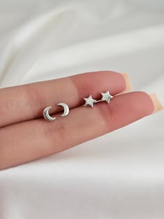 These stunning sterling silver crescent moon star earring studs are crafted with minimalist perfection, these studs feature a classic crescent moon, or star shape for a timeless touch of celestial beauty. Measuring approximately 6mm in size and made from nickel-free sterling silver, you won't have to worry about any irritation or allergies. The design is so simple and elegant that it can be worn day or night and still look amazing. Whether paired with an everyday outfit or an evening gown, these crescent moon star earrings will be sure to turn heads. Lightweight and comfortable, you'll have no problem wearing them all day long if you choose. Finish: platinum plated over sterling silver. Size: Moon 6mm, star 5.5mm Post size: 20 gauge. Post length: 11mm Sold as a pair Mix match available Com Simple Silver Stud Earrings, Stud Silver Earrings, Silver Christmas Earrings, Dainty Silver Star Earrings, Bff Earrings, Silver Star Stud Earrings, Dainty Moon-shaped Sterling Silver Earrings, Moon And Star Earrings Studs, Crescent Moon Earrings Studs