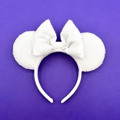 "The bridal ears you've been dreaming of Our ears are super lightweight as they are completely sewn, with NO GLUE, won't melt and fall apart in the Florida heat. Ears are made from white sequin fabric that sparkle in the sunshine. The bow is made from matching white sequins and lightly stuffed for added volume.   The headband is covered with matching white velvet, is 1 inch wide, won't pinch your head, but will still stay in place. Perfect for your trips to any of the Parks or if you want to add a little extra magic to any day. The ears are stuffed with 1/4\" foam and Poly-Fil, so they will maintain their shape for years of magical memories. Wedding veil option! Make any pair of ears wedding-ready with our removable tulle veil.  How you may ask? Just unsnap the veil from the headband and y White Cat Ears Headband For Party, Adjustable White Cat Ears Headband, Party White Ears Headband, Disney Mouse Ears, Sequin Wedding, Tulle Veils, Mouse Ears Headband, Disney Mouse, White Velvet