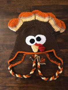 a crocheted turkey hat on top of a wooden table