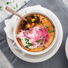 a white bowl filled with food on top of a table