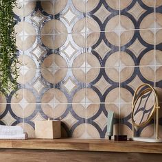 a wooden shelf with some plants and other items on it next to a tiled wall