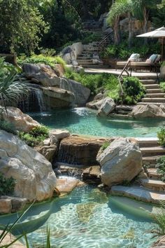 an outdoor pool with steps leading up to it and a waterfall running down the side