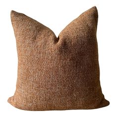 a brown pillow sitting on top of a white wall