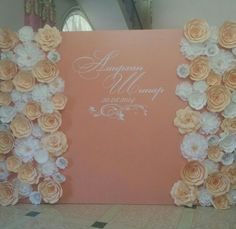 an orange and white wedding card with flowers on the front is displayed against a wall