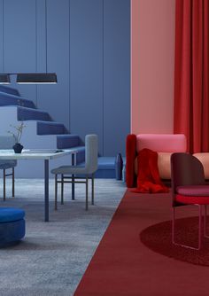 a living room filled with furniture next to a stair case covered in red and blue curtains