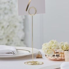 there is a place card holder on top of a table with plates and napkins