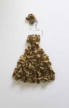 a woman in a dress made out of leaves