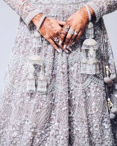 a close up of a woman's hands wearing jewelry