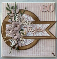 a close up of a card with flowers on the front and an arrow in the back