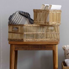 two wicker baskets sitting on top of a wooden table