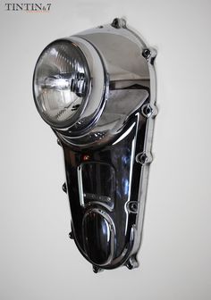 a close up of a headlight on a white wall