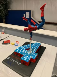 a spiderman birthday cake on top of a table