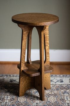 a small wooden table sitting on top of a rug