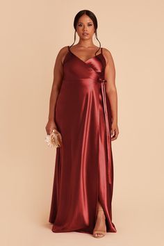 a woman in a long red satin dress with a slit down the side, and her hand on her hip