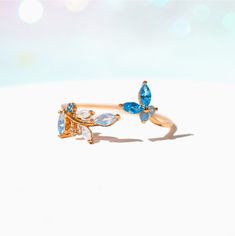 This ring is oh, so perfect. From the radiant array of blue crystals to the adjustable nature of the band, this ring has so many elements that only adds to it's elegance. Featuring a string of leaves on one end and a cute little butterfly on the other, our Perfect Petal Ring is just the piece to add to your garden of jewels. Petal Ring, Little Butterfly, Gold Girl, Necklace Chain Lengths, Fancy Jewelry, Cute Rings, Fantasy Jewelry, Girly Jewelry, Wrap Rings