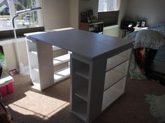 a white desk with shelves in a bedroom