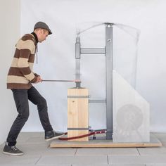 a man is using a hammer to lift a piece of wood