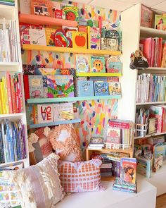 the bookshelves are filled with children's books