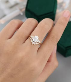 a woman's hand holding a diamond ring