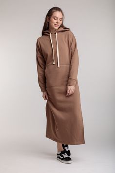 An original long dress with a straight cut made of warm fleece fabric that will help you stay stylish on cool days. A nice expensive fabric will give you warmth and comfort in autumn and winter seasons. Loose-fitting hooded design with drawstrings and long cuffed sleeves. A convenient kangaroo pocket on the front with a stylish small logo to match the dress. The model is decorated with convenient slits on both sides. The dress fits perfectly on any form and is well combined with various shoes an Hoodie Dress Outfit, Travel Hoodie, Midi Dress Outfit, Effortless Outfit, Dress Beige, Hooded Dress, Lounge Dress, Athleisure Fashion, Comfy Fashion