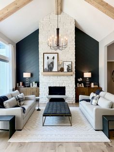 a living room with two couches and a coffee table in it, next to a fireplace