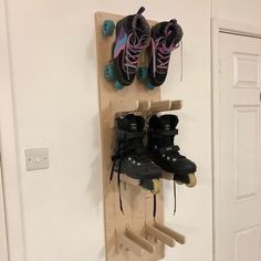 a pair of skates are mounted to a wooden rack