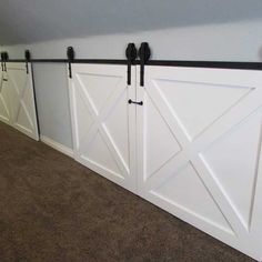 a white garage door with black hardware on it