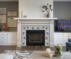 a living room filled with furniture and a fire place in front of a flat screen tv