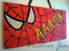 a spiderman sign hanging on the wall with words aron painted on it's side