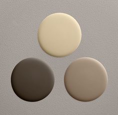 three white and gray circles on a light grey background, with one black circle in the middle