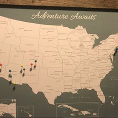 a map with pins on it and the words adventure awaits